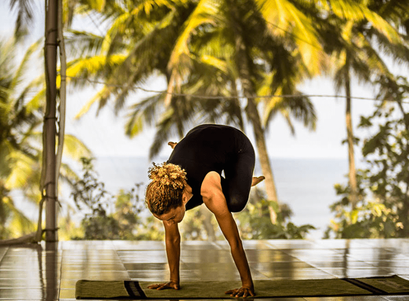 Joanna Vladescu in an arm balance pose in Goa, India