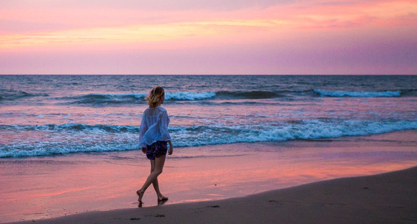 Girl walking on the beach in Goa, India