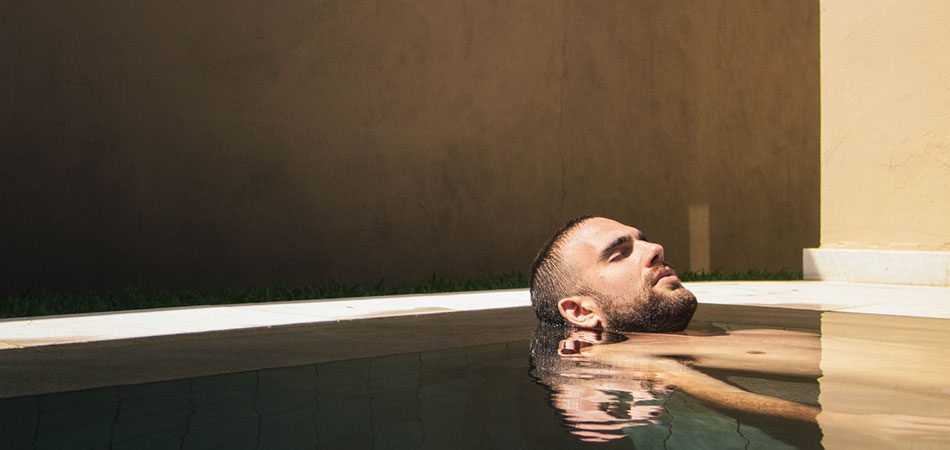 man floating above water to relax his mind