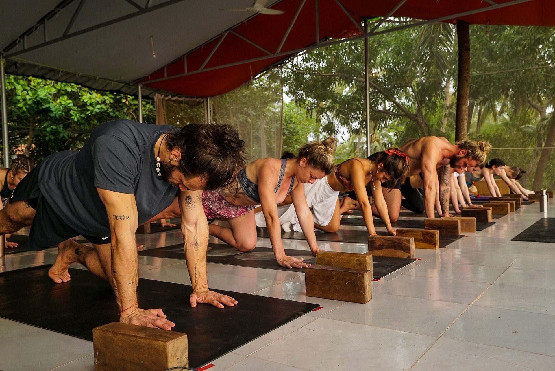 yoga students in the training, with blocks under their hands