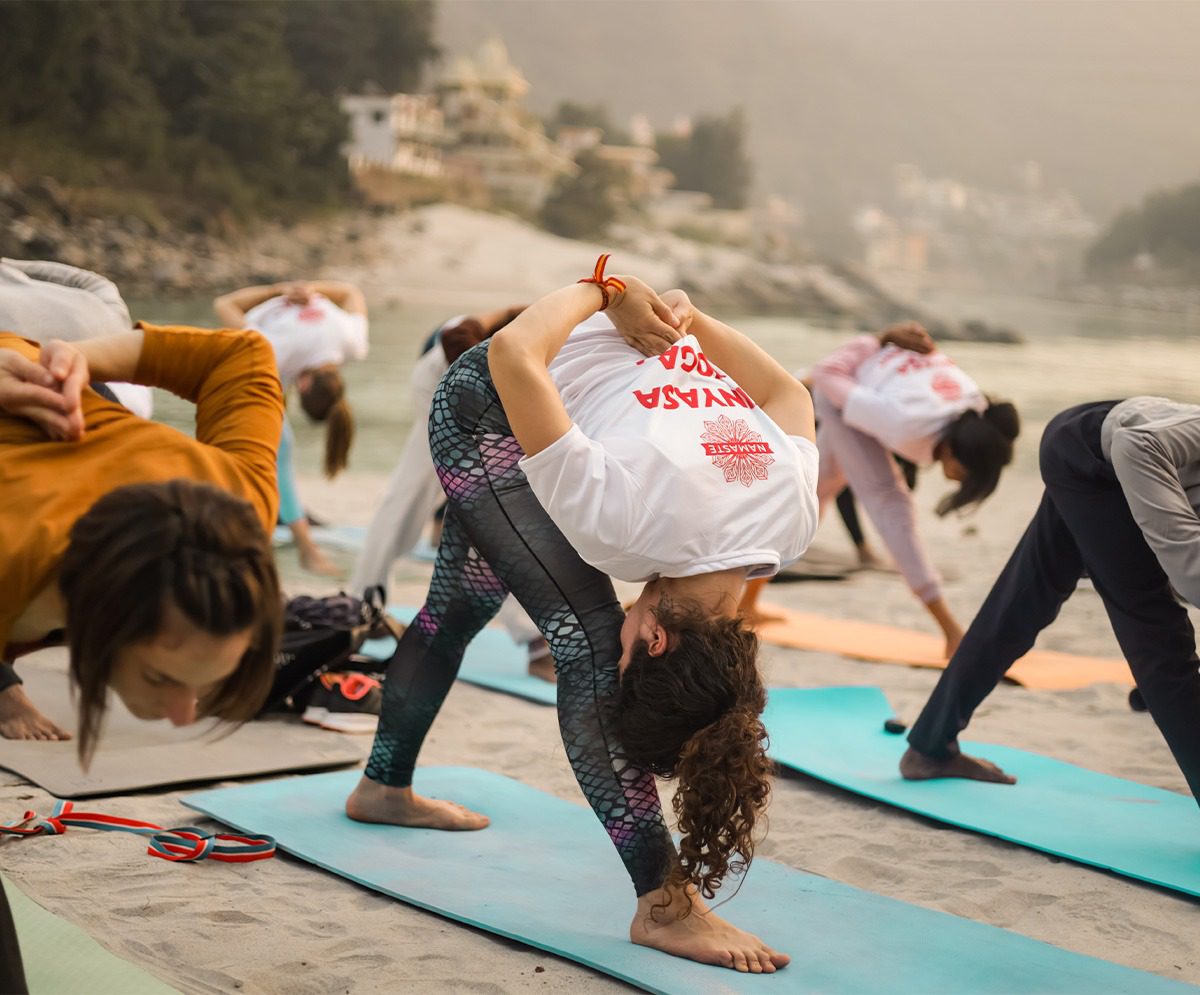 people doing yoga outdoor, during yoga training in India