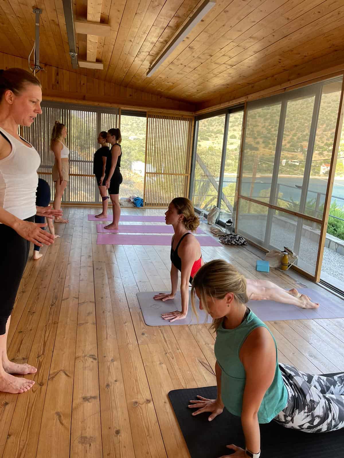 Yoga students practice their teaching skills in the studio during a yoga teacher training course
