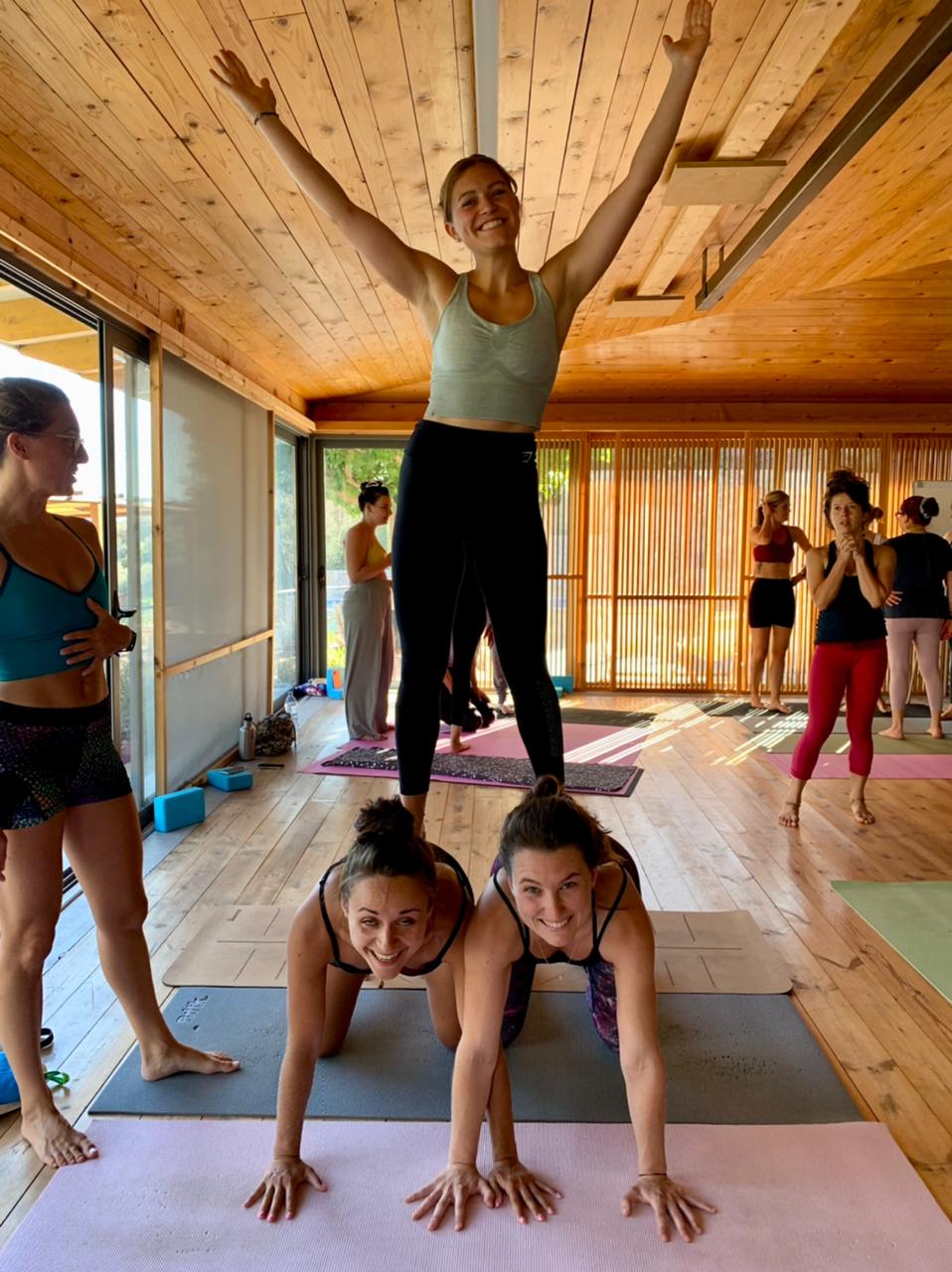 Yoga students doing partner yoga in their yoga teacher training in Greece
