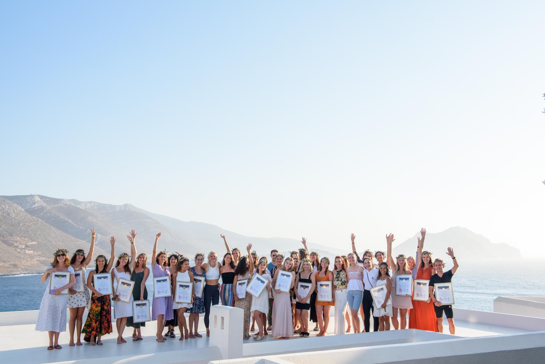 Gratuates at a yoga teacher training school in Greece with a beautiful ocean view