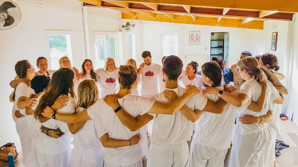 Group hug at yoga teacher training course with Arhanta Yoga in Europe