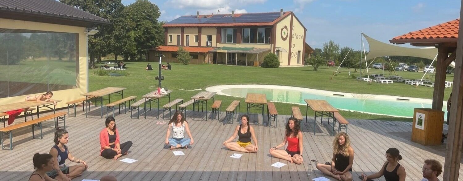 Hari Om yoga school in Europe where yoga students sit under the open sky during yoga teacher training