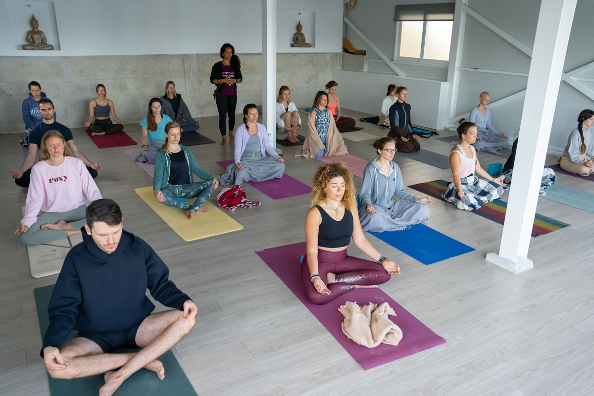 Class at Yoga Union in Europe, students meditating in the studio