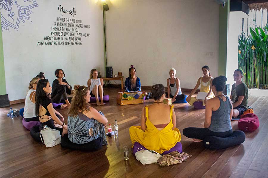 Yoga students sitting in a circle at Yoga Dunia during their yoga teacher training in Bali.