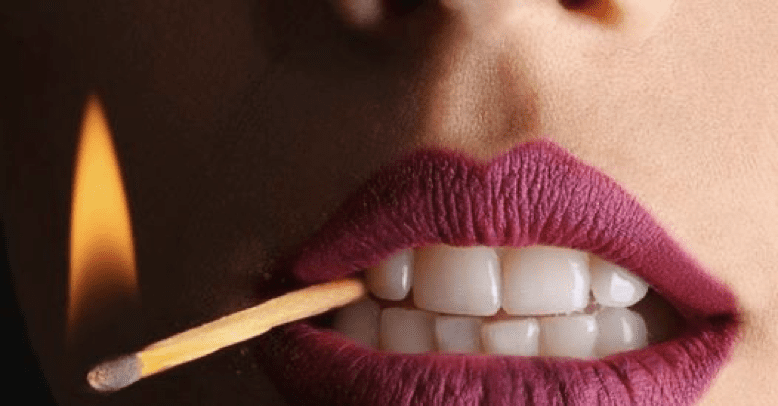 Lit match is held between a person's teeth. Blame is like a lit match.